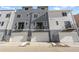 Rear view of modern townhomes each featuring a private garage and upper-level balcony at 14261 Currant St, Broomfield, CO 80020
