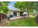 Relax in your backyard with this outdoor deck with covered patio featuring a table, chairs, and grill at 17692 E Brunswick Pl, Aurora, CO 80013