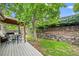 Enjoy outdoor living with a backyard deck, patio table and chairs, under a mature shade tree at 17692 E Brunswick Pl, Aurora, CO 80013