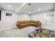 This basement Gathering room has carpet, and a sectional couch. There is also a play area for  at 17692 E Brunswick Pl, Aurora, CO 80013