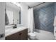 Bathroom features tiled shower and planked wall at 17692 E Brunswick Pl, Aurora, CO 80013