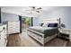 This is a bedroom with a sliding glass door and a bed with a white headboard and a gray comforter at 17692 E Brunswick Pl, Aurora, CO 80013
