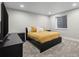 This is a basement bedroom with gray carpet, black furniture, and a yellow bedspread at 17692 E Brunswick Pl, Aurora, CO 80013