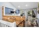 Modern kitchen with blue cabinets, stainless steel appliances, and a view of the outdoor dining area at 17692 E Brunswick Pl, Aurora, CO 80013