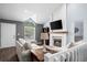 Cozy living room features a fireplace, large windows and a modern design that is perfect for relaxing at 17692 E Brunswick Pl, Aurora, CO 80013