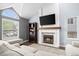 Comfortable living room features a fireplace and large windows, creating a warm and inviting atmosphere at 17692 E Brunswick Pl, Aurora, CO 80013