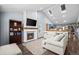 Bright, open living room with a fireplace, hardwood floors and views of the kitchen and dining area at 17692 E Brunswick Pl, Aurora, CO 80013
