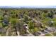 Aerial shot of a neighborhood with lush greenery and mature trees, with the cityscape in the distance at 949 Pontiac St, Denver, CO 80220