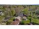 A high angle aerial view of a well-maintained home with a lush lawn and detached garage in a green neighborhood at 949 Pontiac St, Denver, CO 80220