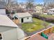 An aerial view of a tidy backyard and detached garage in a residential neighborhood at 949 Pontiac St, Denver, CO 80220