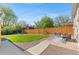 Expansive backyard featuring lush green grass, patio area, and a privacy fence at 949 Pontiac St, Denver, CO 80220