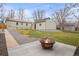 A backyard featuring a cozy fire pit and a detached garage at 949 Pontiac St, Denver, CO 80220