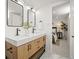 Bright bathroom featuring a double sink vanity with a stone countertop and an adjacent bedroom at 949 Pontiac St, Denver, CO 80220