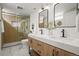 Modern bathroom featuring double sinks, wooden vanities, and a stylish glass-enclosed shower for a spa-like experience at 949 Pontiac St, Denver, CO 80220