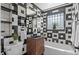 Modern bathroom with black and white tile, stylish vanity, glass shower, and sleek fixtures at 949 Pontiac St, Denver, CO 80220