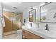 Elegant bathroom with double vanity, modern fixtures, and a glass-enclosed shower at 949 Pontiac St, Denver, CO 80220
