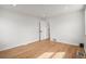 Bright bedroom features wood floors, white walls, and an open closet, creating a clean and modern space at 949 Pontiac St, Denver, CO 80220