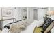 Serene bedroom space featuring a sliding barn door and view into a cozy living area at 949 Pontiac St, Denver, CO 80220