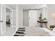 Comfortable bedroom featuring soft textures, a sliding barn door, and cozy sitting area at 949 Pontiac St, Denver, CO 80220