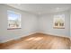 Spacious bedroom featuring hardwood floors and natural light from two windows at 949 Pontiac St, Denver, CO 80220