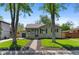 Charming single story home with mature trees, lawn, and a cozy, inviting facade at 949 Pontiac St, Denver, CO 80220