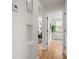 Hallway with hardwood floors and a view into the living room at 949 Pontiac St, Denver, CO 80220