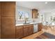 Sunlit kitchen with wood cabinets, stainless steel appliances, and a view to the yard at 949 Pontiac St, Denver, CO 80220