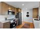 Updated kitchen boasts wood floors, stainless appliances, and white quartz countertops at 949 Pontiac St, Denver, CO 80220
