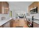Updated kitchen boasts wood floors, stainless appliances, and white quartz countertops at 949 Pontiac St, Denver, CO 80220
