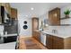 Updated kitchen boasts wood floors, stainless appliances, and white quartz countertops at 949 Pontiac St, Denver, CO 80220