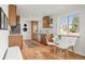 The kitchen and dining area features wood cabinets, modern appliances, and hardwood floors at 949 Pontiac St, Denver, CO 80220