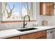 Modern quartz countertops, stylish black faucet, and pyramid tile backsplash in the kitchen at 949 Pontiac St, Denver, CO 80220