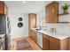 Bright kitchen with wood cabinets, quartz countertops, stainless steel appliances, and decorative backsplash at 949 Pontiac St, Denver, CO 80220