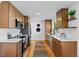 Open concept kitchen features modern cabinetry, stainless appliances, and an eat-in area at 949 Pontiac St, Denver, CO 80220