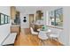 Modern kitchen with stainless steel appliances, bright white walls, and cozy dining area at 949 Pontiac St, Denver, CO 80220