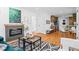 Bright living room featuring a fireplace, open layout, and easy access to kitchen and other spaces at 949 Pontiac St, Denver, CO 80220