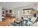 Open living room space with a kitchen and dining nook, filled with natural light at 949 Pontiac St, Denver, CO 80220
