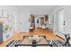 Open-concept living room flows to the kitchen and dining area with hardwood floors, bright and airy feel at 949 Pontiac St, Denver, CO 80220