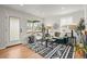 Bright living room with large windows, modern furnishings, and a patterned rug at 949 Pontiac St, Denver, CO 80220