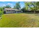 The well-maintained backyard features a lush lawn, a shed, and a sunroom at 7310 Granada Rd, Denver, CO 80221