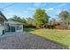 The well-maintained backyard features a patio, large trees, and an enclosed sunroom at 7310 Granada Rd, Denver, CO 80221