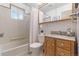 Bathroom with shower and tub and vanity with granite countertop at 7310 Granada Rd, Denver, CO 80221