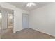 This is a cozy bedroom with carpet flooring, a ceiling fan, and a closet at 7310 Granada Rd, Denver, CO 80221