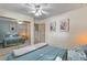 Bedroom with queen bed and mirrored closet, reflecting the room and bed at 7310 Granada Rd, Denver, CO 80221
