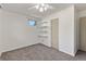 Bedroom with closet and storage shelves and a large window at 7310 Granada Rd, Denver, CO 80221