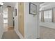 Hallway featuring a hallway closet with drawers, leading to the kitchen and bedroom at 7310 Granada Rd, Denver, CO 80221