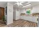 Bright kitchen featuring white appliances, tile backsplash, and modern flooring for a clean and welcoming space at 7310 Granada Rd, Denver, CO 80221