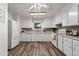 Bright kitchen with white appliances, tile backsplash, and modern flooring for a clean and welcoming space at 7310 Granada Rd, Denver, CO 80221