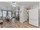 Living room featuring hardwood floors and lots of natural light, flowing into the dining area at 7310 Granada Rd, Denver, CO 80221