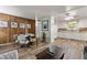 Open-concept living room and kitchen area featuring light walls, hardwood floors, and modern furnishings at 7310 Granada Rd, Denver, CO 80221